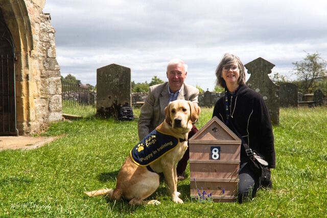 two people with guide dog